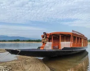 A wooden houseboat moored at the shore